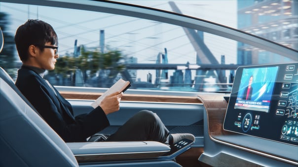 A person riding in a futuristic self-driving robotaxi